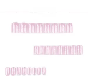 Detail view of pink glitter press-on nails set in various sizes on a white background