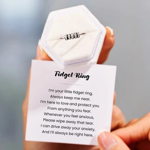 Close-up of S925 sterling silver fidget ring with colorful zircon and message card