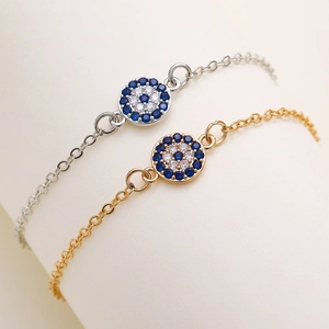 Exquise Evil Eye armband in goud en zilver met sprankelende blauwe zirkonia steentjes
