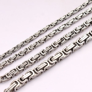 Detail of various thicknesses of stainless steel Byzantine chains in a diagonal layout