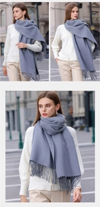Detailed macro view showing the blue cashmere scarf texture and classic fringe tassels