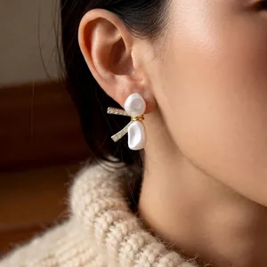 18k gold plated bow stud earrings with pearls and crystals worn by a model