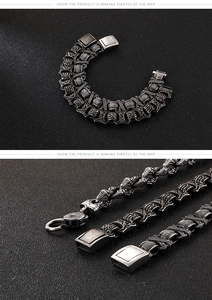 Detailed macro view of vintage titanium steel bracelet with rune carvings and woven texture
