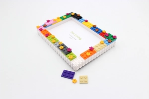 Close-up of DIY building block photo frame with colorful stars for 4x6 inch pictures