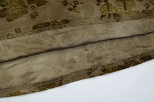 Detail shot of tie-dye dress hem featuring floral velvet burnout on sheer mesh fabric