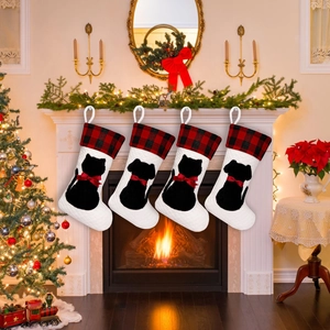 Quilted Christmas stockings with pet silhouettes hanging on a white fireplace mantel