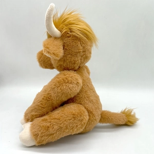 Side view of realistic brown plush Highland Cow with curved horns and long soft fur texture