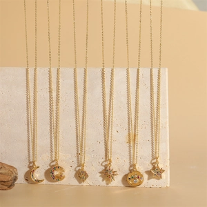 Gold-plated star and moon pendant necklaces with colorful zircon stones on textured stone