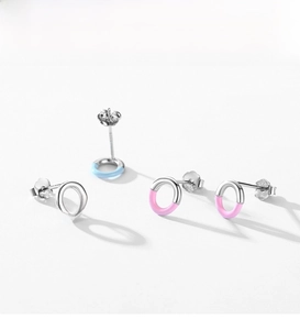 Close-up of S925 sterling silver stamp on minimalist blue and pink enamel stud earrings