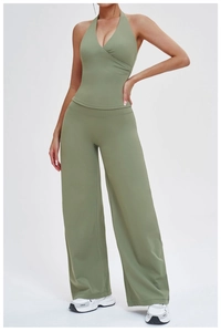 Detail of sage green halter yoga top and high-waisted wide-leg sports trousers