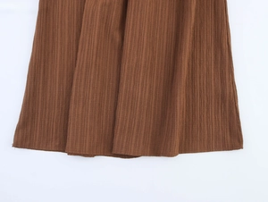 Detailed macro view of the brown ribbed fabric texture on this vacation style maxi skirt