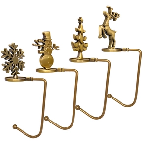 Set of four vintage bronze metal Christmas stocking hooks with festive holiday figures