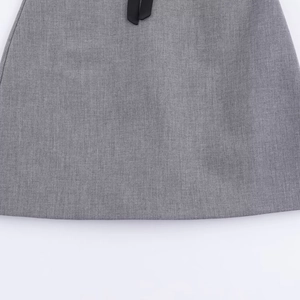 Short grey fashion dress with black bow detail and high-quality textured fabric