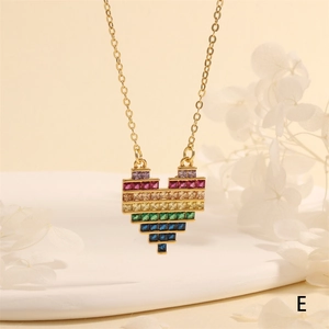 Detailed close-up of a golden heart necklace featuring vibrant rainbow baguette gemstones