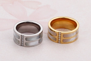 Macro detail of wide shell ring with 18k gold plating and sparkling cubic zirconia inlay
