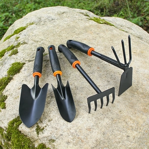 Macro shot of 4-piece garden tool set with non-slip handles on natural mossy rock