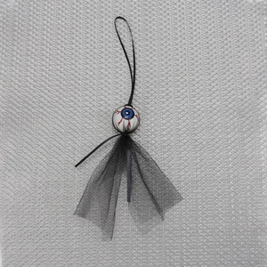 Close-up of a Halloween eyeball ornament with red veins and black mesh tutu detail