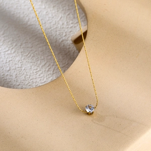 Elegant 18K gold plated titanium necklace featuring a sparkling round zircon pendant