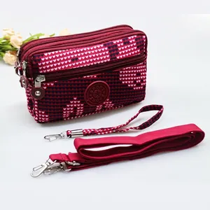Red heart print crossbody mobile phone bag with three zippers and detachable straps