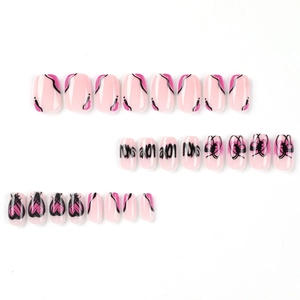 Pink press-on nails set with black abstract lines, butterfly and heart patterns