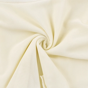 Close-up of cream knit mesh fabric showing breathable texture and micro-fiber detail