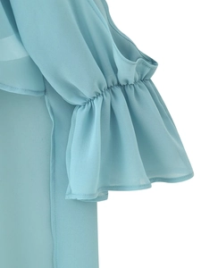 Detailed close-up of light blue chiffon fabric showing tiered ruffle cuff design