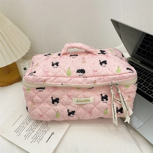 Pink quilted makeup bag with puppy and pear prints and comfortable carry handle