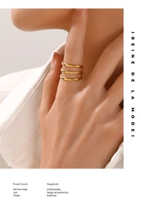 Close-up of a three-layered 18K gold-plated adjustable ring featuring smooth and twisted bands
