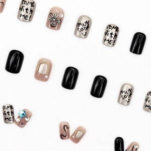Press-on nail set featuring black and silver styles with metal cross and 3D rhinestones