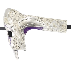 Detail of silver Venetian masquerade mask with purple patterns and filigree texture