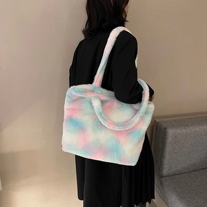 Detail of pink blue tie-dye plush corduroy tote bag showing soft texture on a shoulder