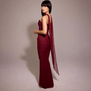 Detail view of deep red backless dress with elegant ribbon tie and ruched texture