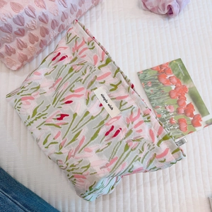 Pink cherry blossom jacquard makeup bag with simple wish label on white bedding