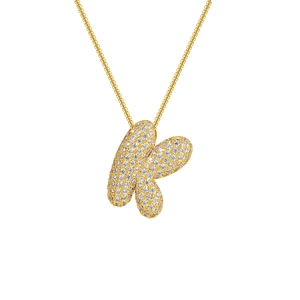 Macro shot of 18K gold plated letter K pendant with sparkling pave set zircons