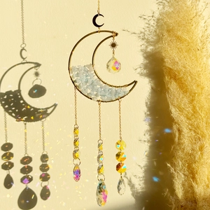 Golden moon crystal suncatcher with blue stones and prisms casting colorful light