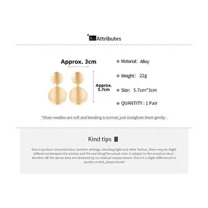 Detailed view of gold circular brushed drop earrings with 5.7cm size specifications