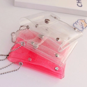 Detail of glitter transparent card wallets with silver ball chains and snap closure