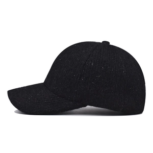 Black winter baseball cap with white speckled fleece texture and structured curved brim
