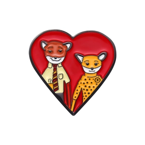 Enamel heart pin badge featuring cartoon fox and cheetah characters on red background