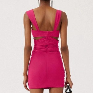 Detail of ruched texture and open back cutout on a fuchsia bodycon mini dress