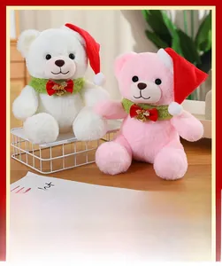 Detailed close-up of white and pink Christmas teddy bears with festive hats and scarves