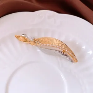 Exquisite French zircon leaf brooch in gold and silver finish with elegant twisted design
