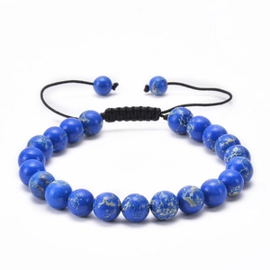 Macro shot of blue natural stone beads with black braided cord and adjustable knot detail