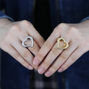 Close-up of hip hop style hollow heart rings in gold and silver with zircon diamonds
