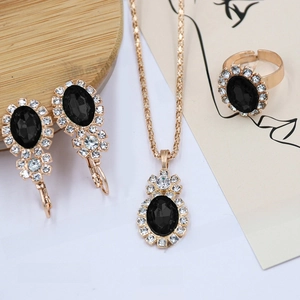 Macro detail of bridal jewelry set with black stones and gold-plated alloy finish