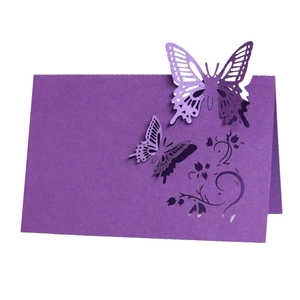 Elegant purple laser-cut butterfly place card with intricate hollow design for weddings