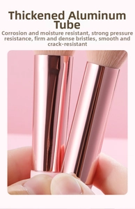 Detailed close-up of thickened rose gold aluminum tube on peach pink makeup brush