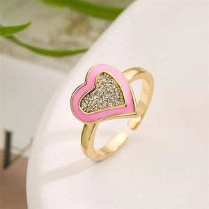 Macro shot of pink enamel heart ring with micro-set zircons and adjustable gold band