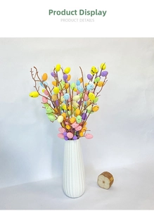 Detail of colorful Easter egg branches with speckled texture in a minimalist white vase