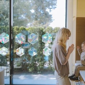 Rainbow prism hexagonal window films showing holographic light effect in a home setting